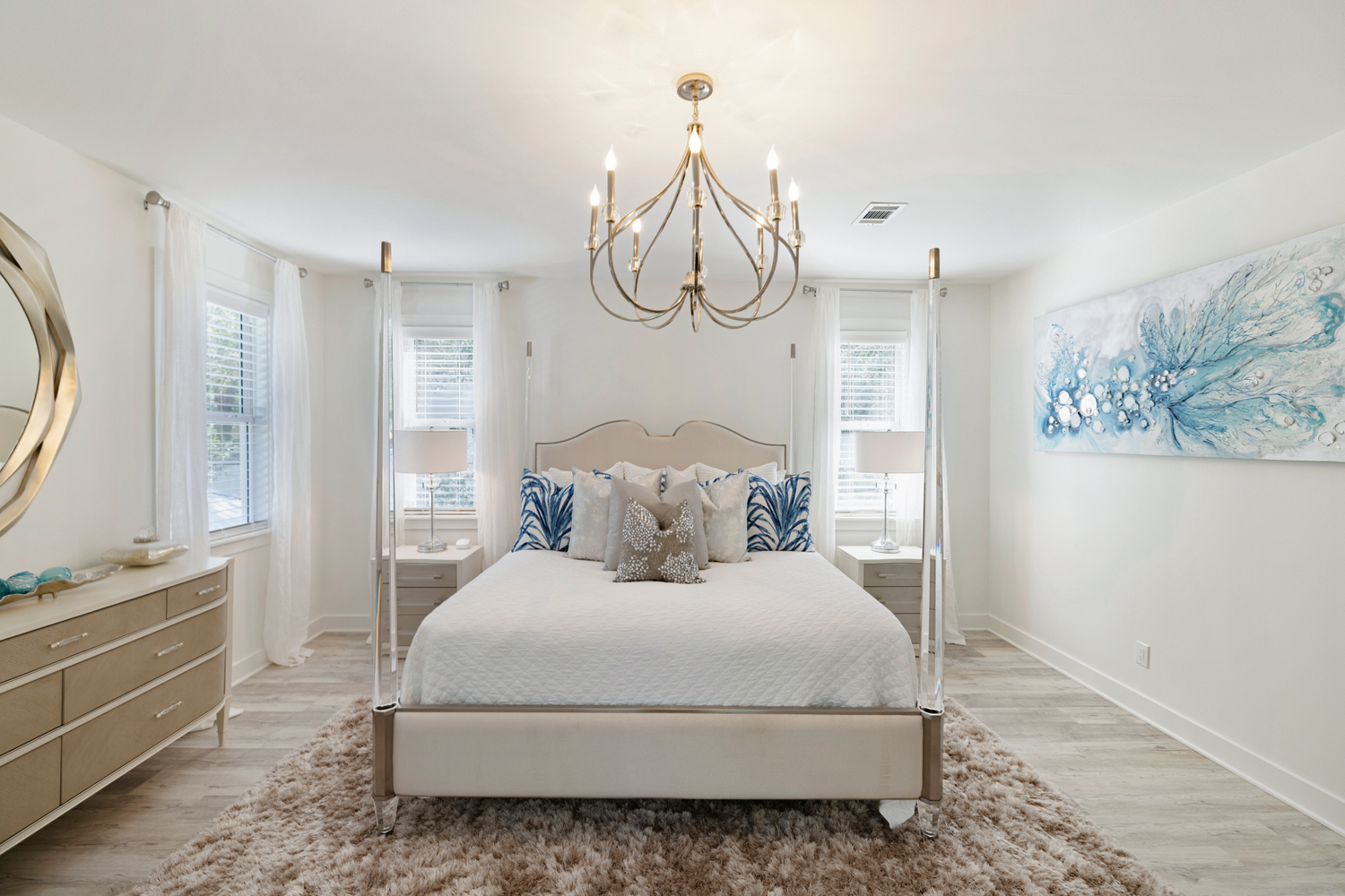 King bedroom with four-poster bed and chandelier