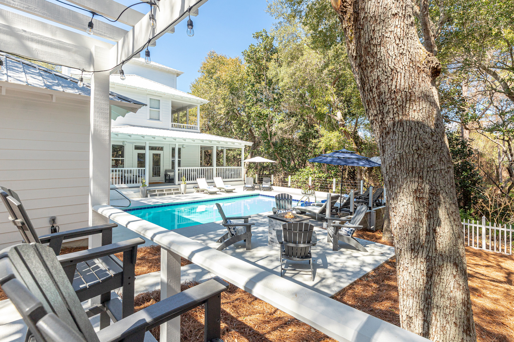 Caught By A Wave 30A — exterior with fire feature and pool at dusk